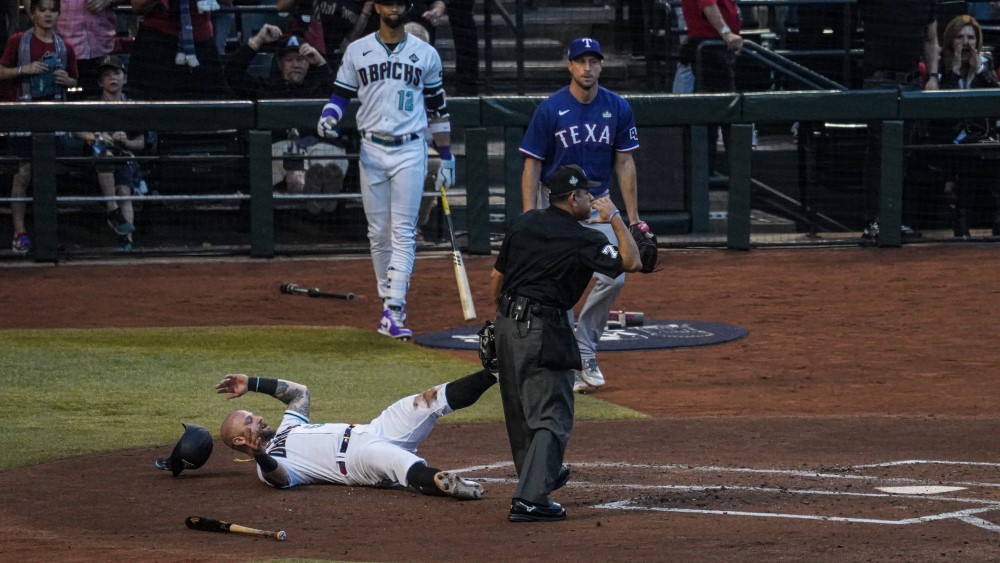 Arizona Diamondbacks first baseman Christian Walker is thrown out at the plate by Texas Rangers rig...