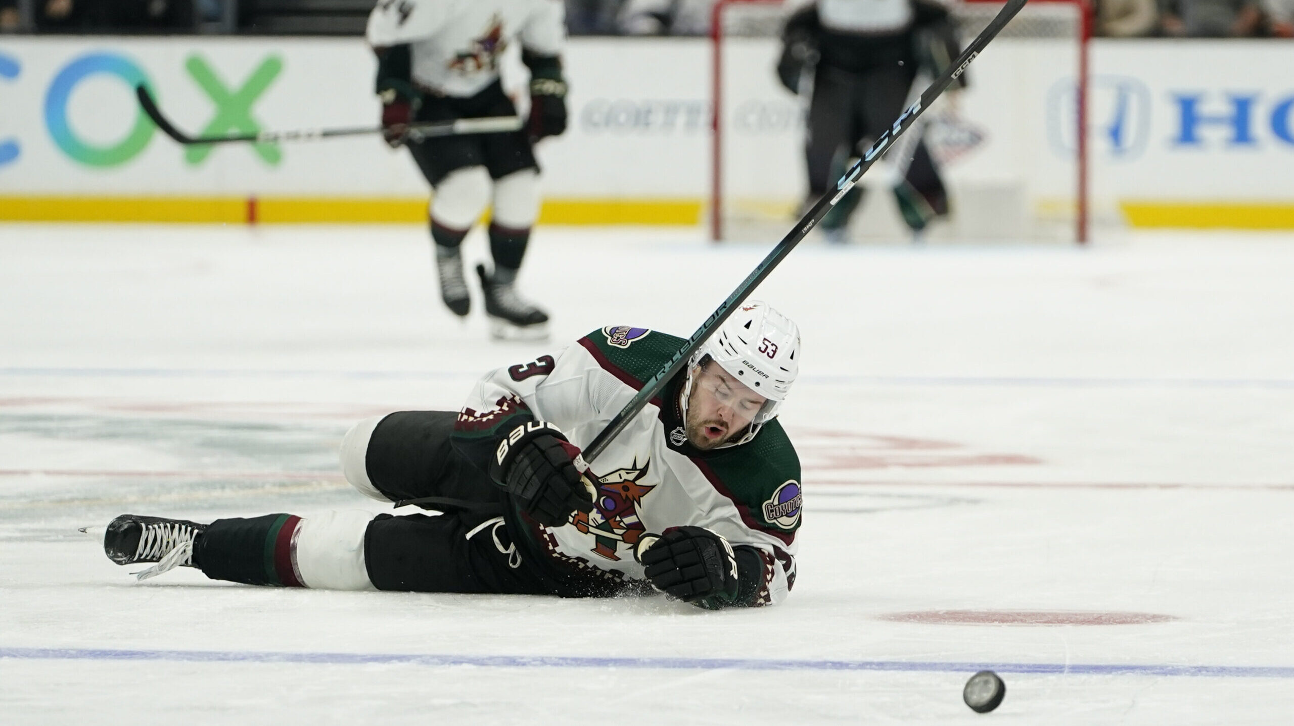 Arizona Coyotes left wing Michael Carcone falls while chasing the puck during the second period of ...