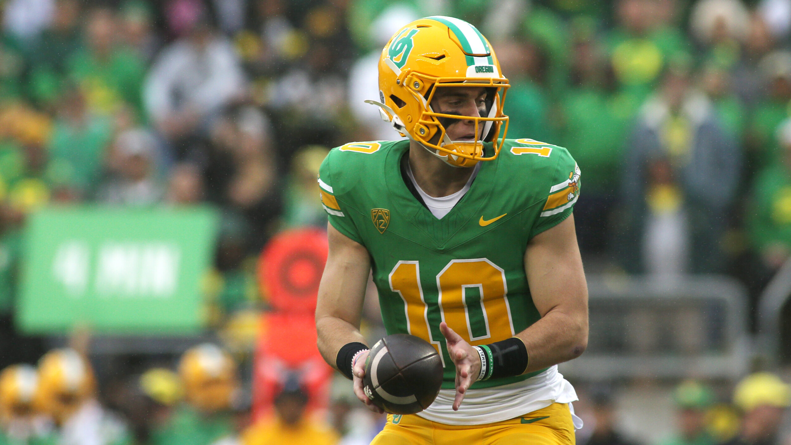 Bo Nix #10 of the Oregon Ducks prepares to hand off the ball in the second half against the Washing...