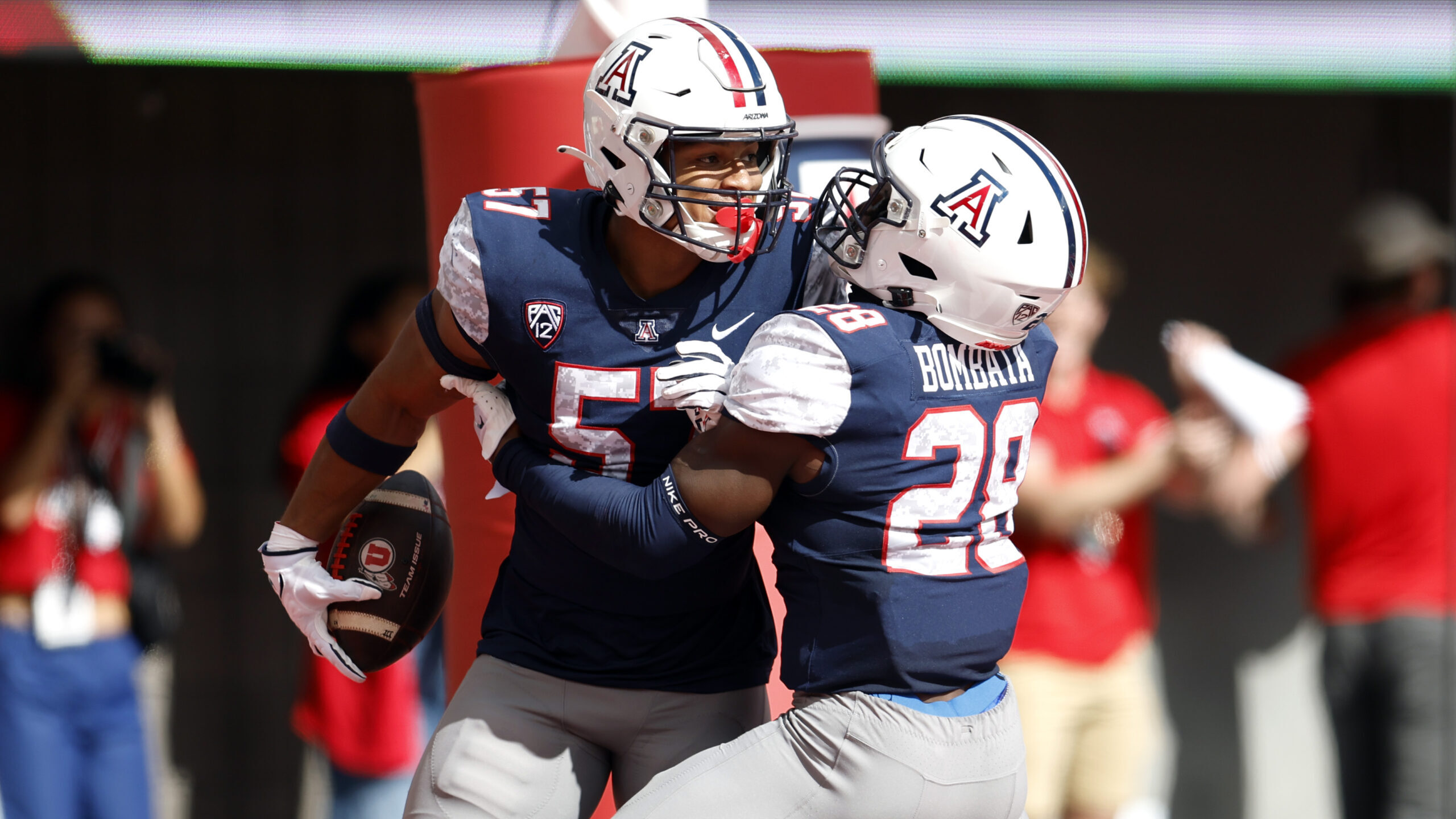 Linebacker Anthony Ward #57 of the Arizona Wildcats reacts with running back Nazar Bombata #28 afte...