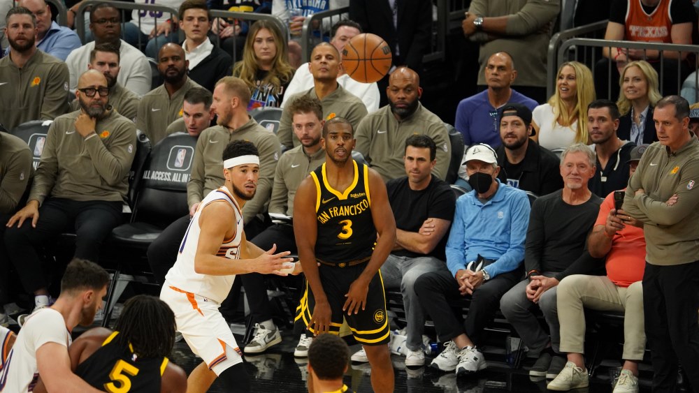 Phoenix Suns guard Devin Booker and Golden State Warriors guard Chris Paul (Felisa Cardenas/Arizona...