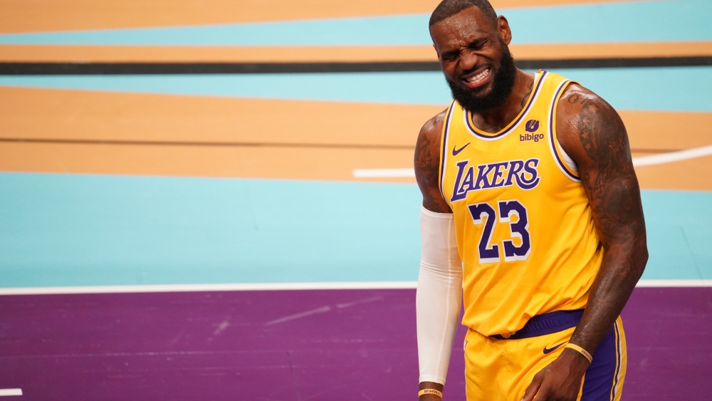 LeBron James winces after a leg injury, Lakers...