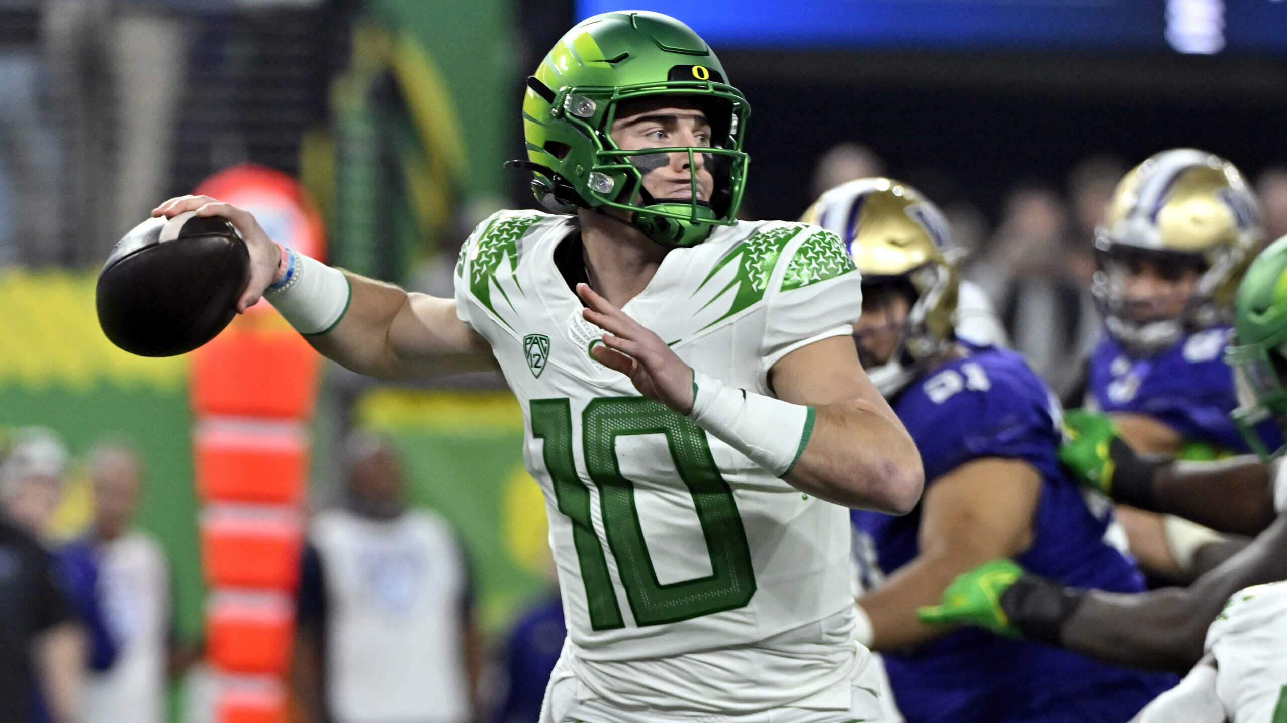 Oregon quarterback Bo Nix looks to pass against Washington during the first half of the Pac-12 cham...