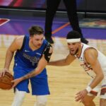 Suns guard Devin Booker defending Mavericks guard Luka Doncic (Jeremy Schnell/Arizona Sports)