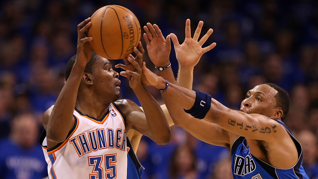 Kevin Durant #35 of the Oklahoma City Thunder moves the ball as Shawn Marion #0 of the Dallas Maver...