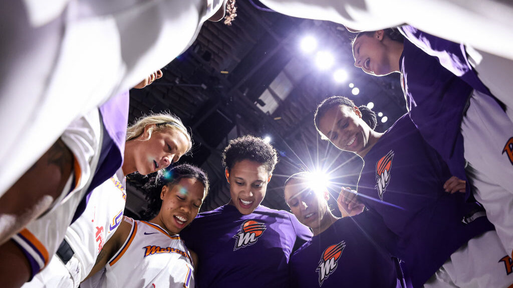Brittney Griner #42 and Diana Taurasi #3 of the Phoenix Mercury gather their teammates before the g...