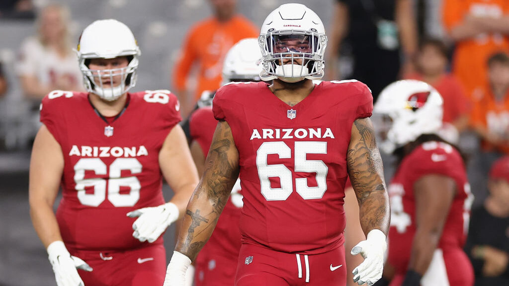 Offensive tackle Elijah Wilkinson #65 of the Arizona Cardinals warms up before the NFL game at Stat...