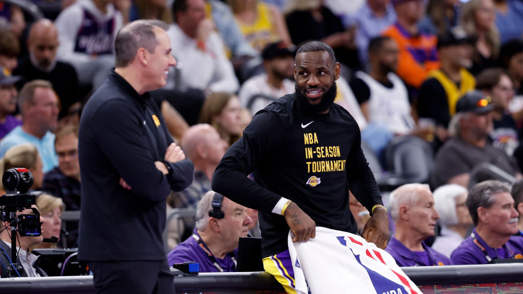 LeBron James #23 of the Los Angeles Lakers talks with head coach Frank Vogel of the Phoenix Suns du...