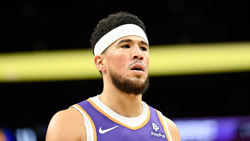 Devin Booker #1 of the Phoenix Suns looks on during the first half of the NBA game against the Sacr...