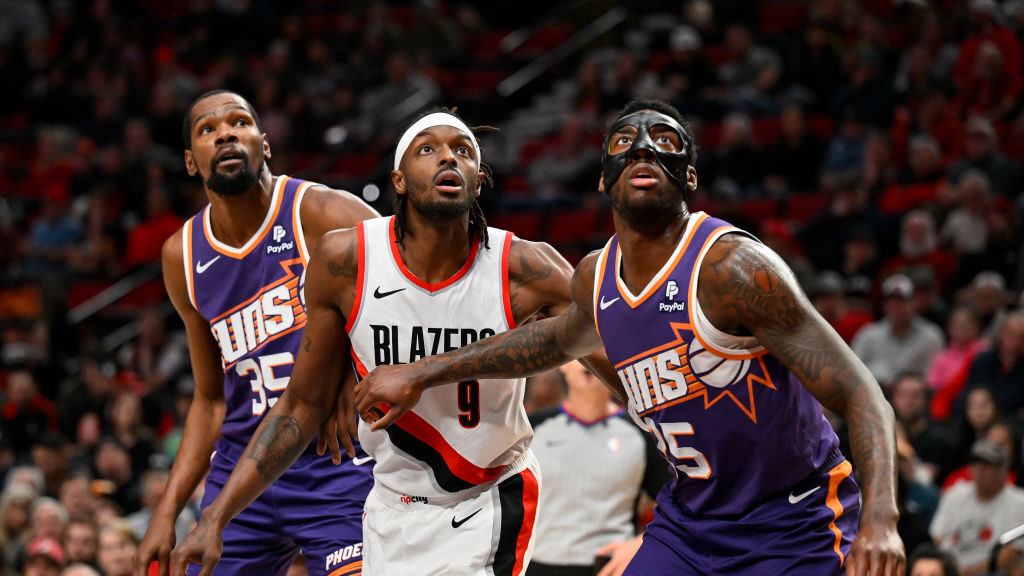 Jerami Grant #9 of the Portland Trail Blazers, Kevin Durant #35 and Nassir Little #25 of the Phoeni...