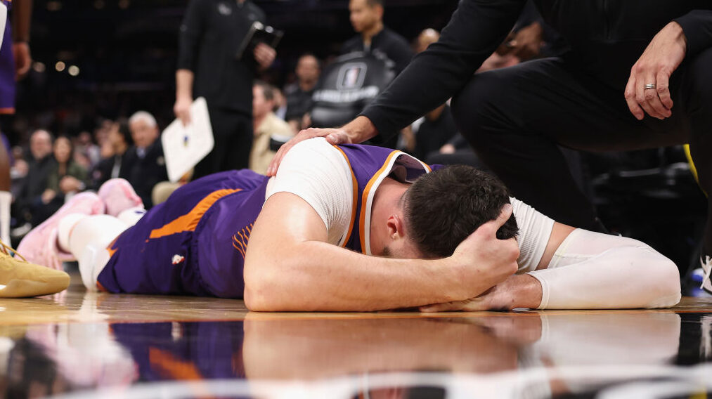 Jusuf Nurkic of the Phoenix Suns after getting hit in the face by Draymond Green...