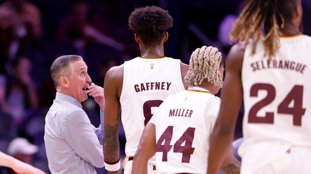 Head coach Bobby Hurley of the Arizona State Sun Devils talks to Alonzo Gaffney #8 during the first...
