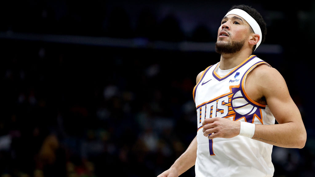 Devin Booker #1 of the Phoenix Suns reacts after a foul during the second quarter of an NBA game ag...
