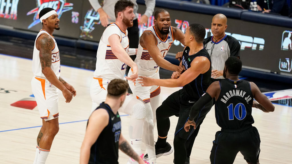 Kevin Durant (C) #35 of the Phoenix Suns shoves Grant Williams #3 of the Dallas Mavericks...