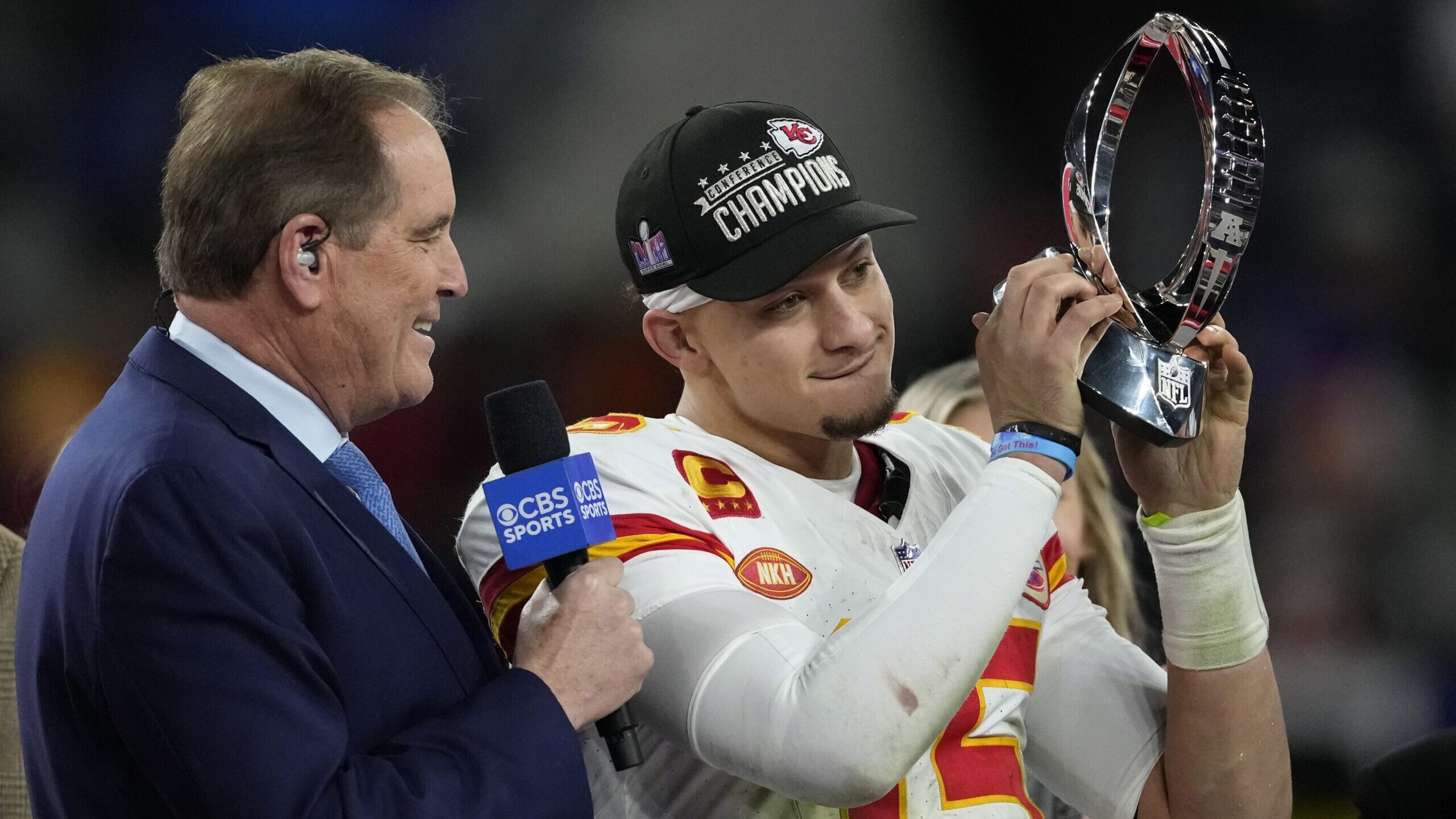 Kansas City Chiefs quarterback Patrick Mahomes (15) holds up the Lamar Hunt Trophy after the AFC Ch...
