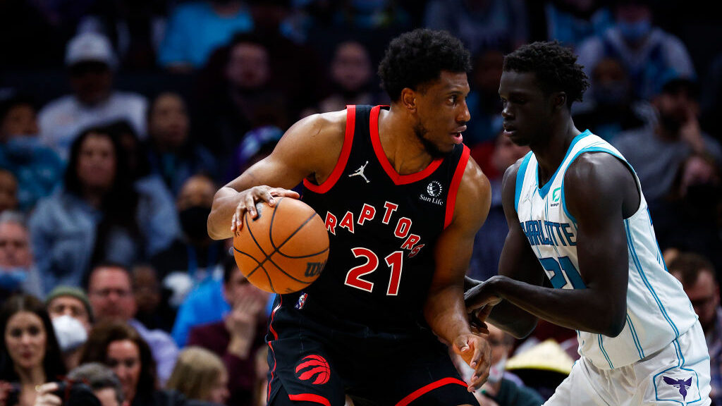 Thaddeus Young #21 of the Toronto Raptors dribbles the ball as JT Thor #21 of the Charlotte Hornets...