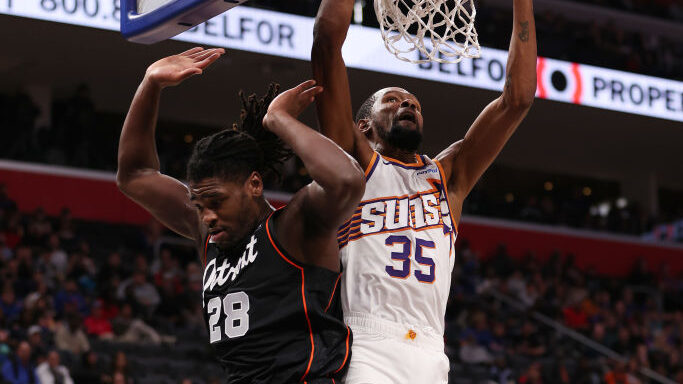 DETROIT, MICHIGAN - NOVEMBER 05: Kevin Durant #35 of the Phoenix Suns dunks past Isaiah Stewart #28...