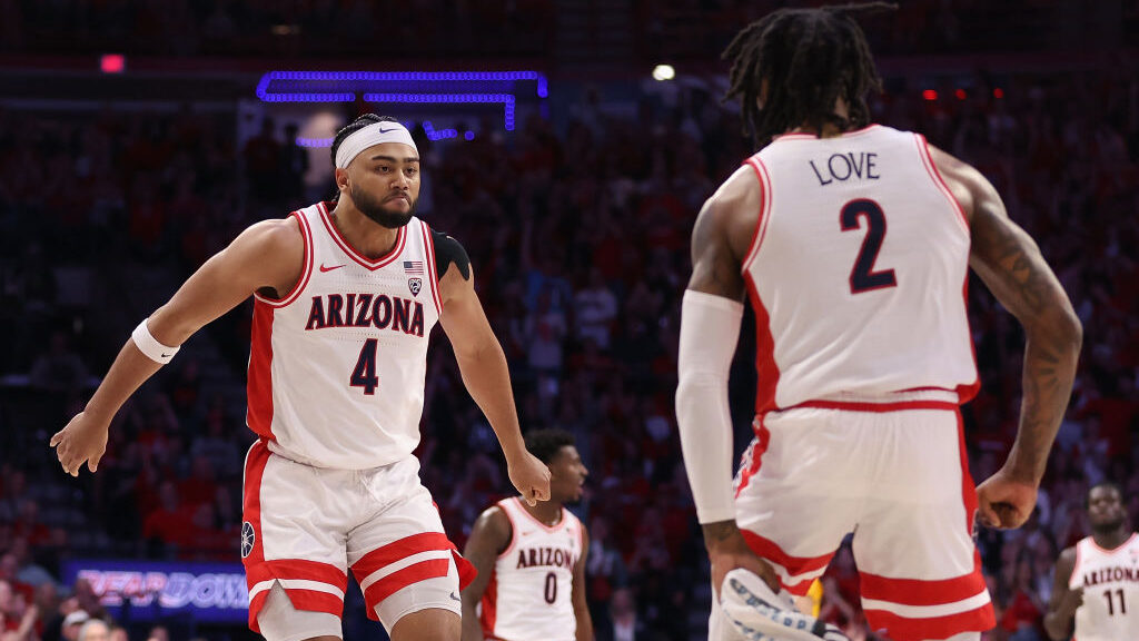 Kylan Boswell #4 of the Arizona Wildcats celebrates with Caleb Love #2 after scoring against the Ar...