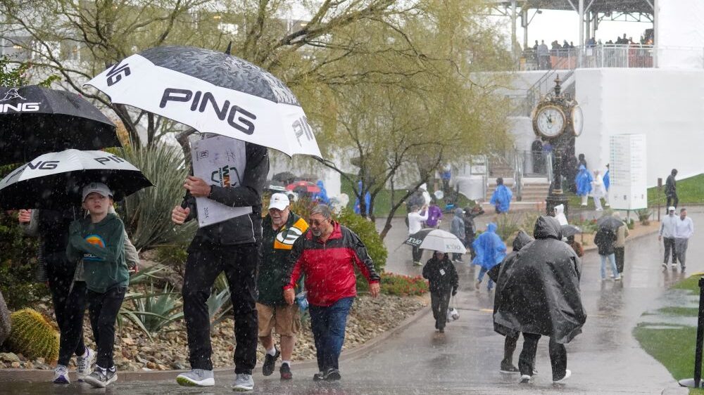 Spectators scatter as rain brings a halt to the Waste Management Phoenix Open Pro-AM on Wednesday. ...
