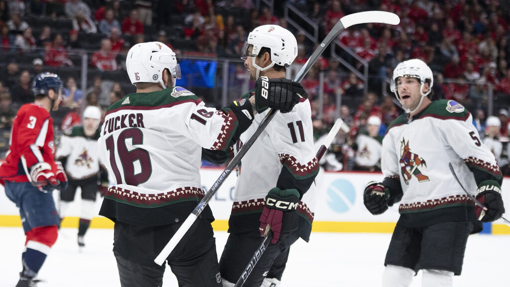 Arizona Coyotes right wing Dylan Guenther (11) is congratulated by left wing Jason Zucker (16) and ...