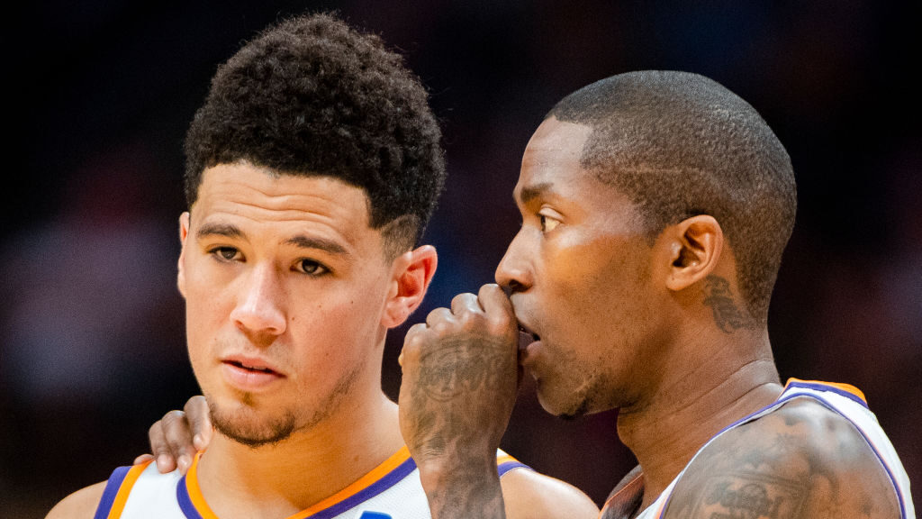 Jamal Crawford #11 of the Phoenix Suns, right, speaks with teammate Devin Booker #1 during the firs...