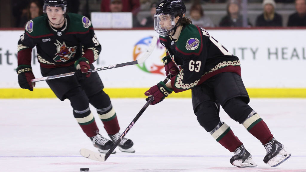 Matias Maccelli #63 of the Arizona Coyotes skates with the puck during an NHL game at Mullett Arena...