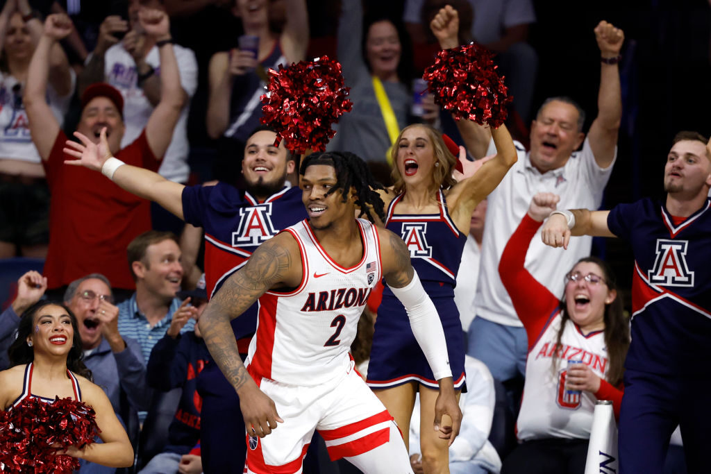 Arizona's Caleb Love celebrates a dunk...