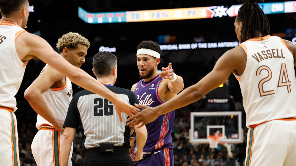 Devin Booker #1 of the Phoenix Suns argues a call with official Pat Fraser n the first half as Jere...