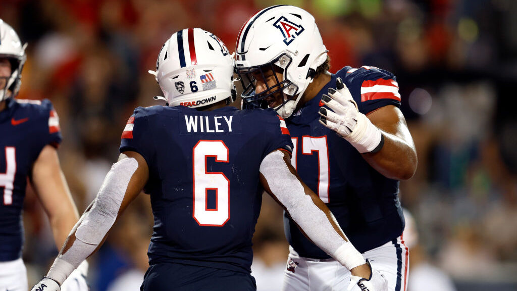 Running back Michael Wiley #6 of the Arizona Wildcats celebrates with offensive lineman Jordan Morg...