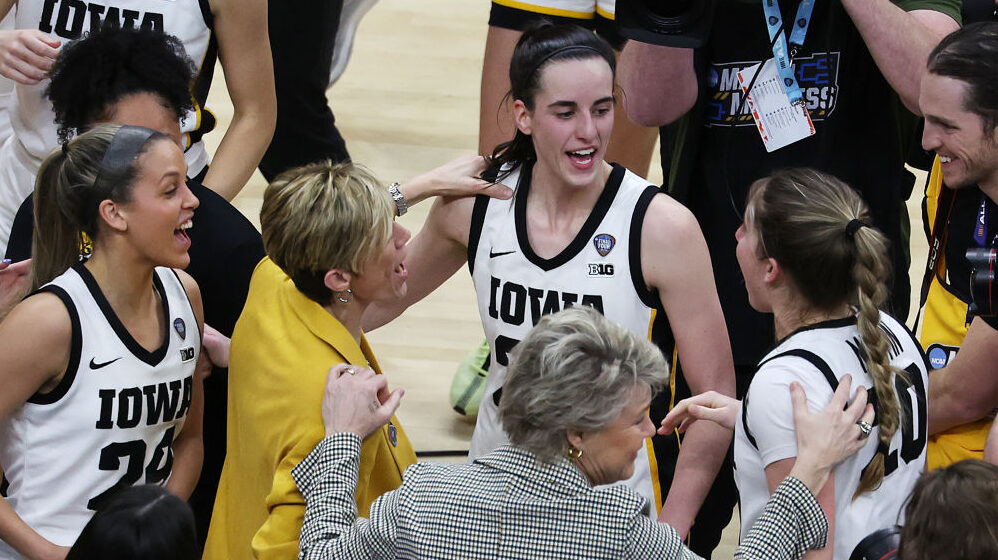 Caitlin Clark and members of the Iowa women's basketball team celebrate their Final Four win over U...