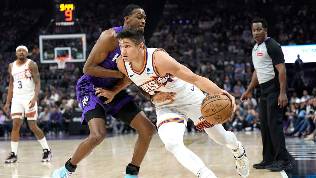 Grayson Allen #8 of the Phoenix Suns drives against De'Aaron Fox #5 of the Sacramento Kings during ...