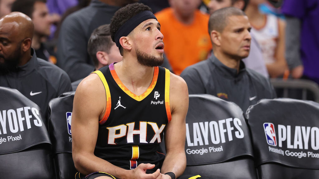 Devin Booker #1 of the Phoenix Suns reacts on the bench during the second half of game three of the...