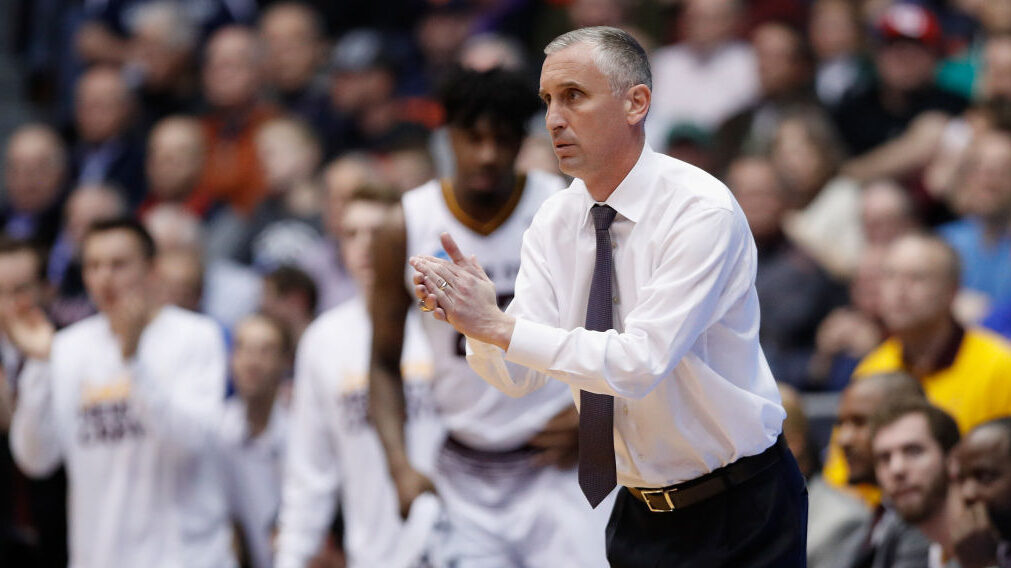 Bobby Hurley claps during a game...