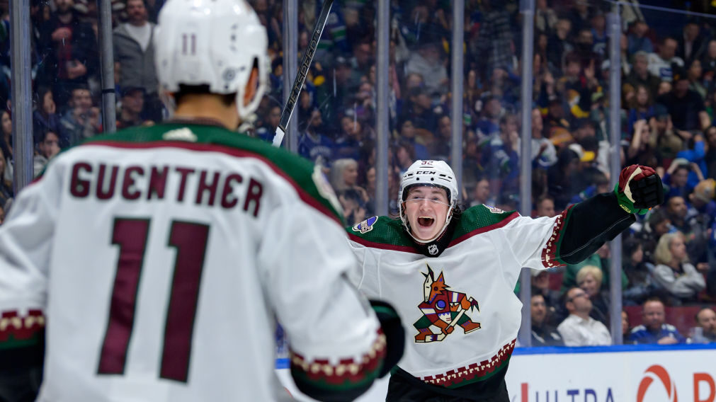 Logan Cooley celebrates with Dylan Guenther of the Arizona Coyotes...