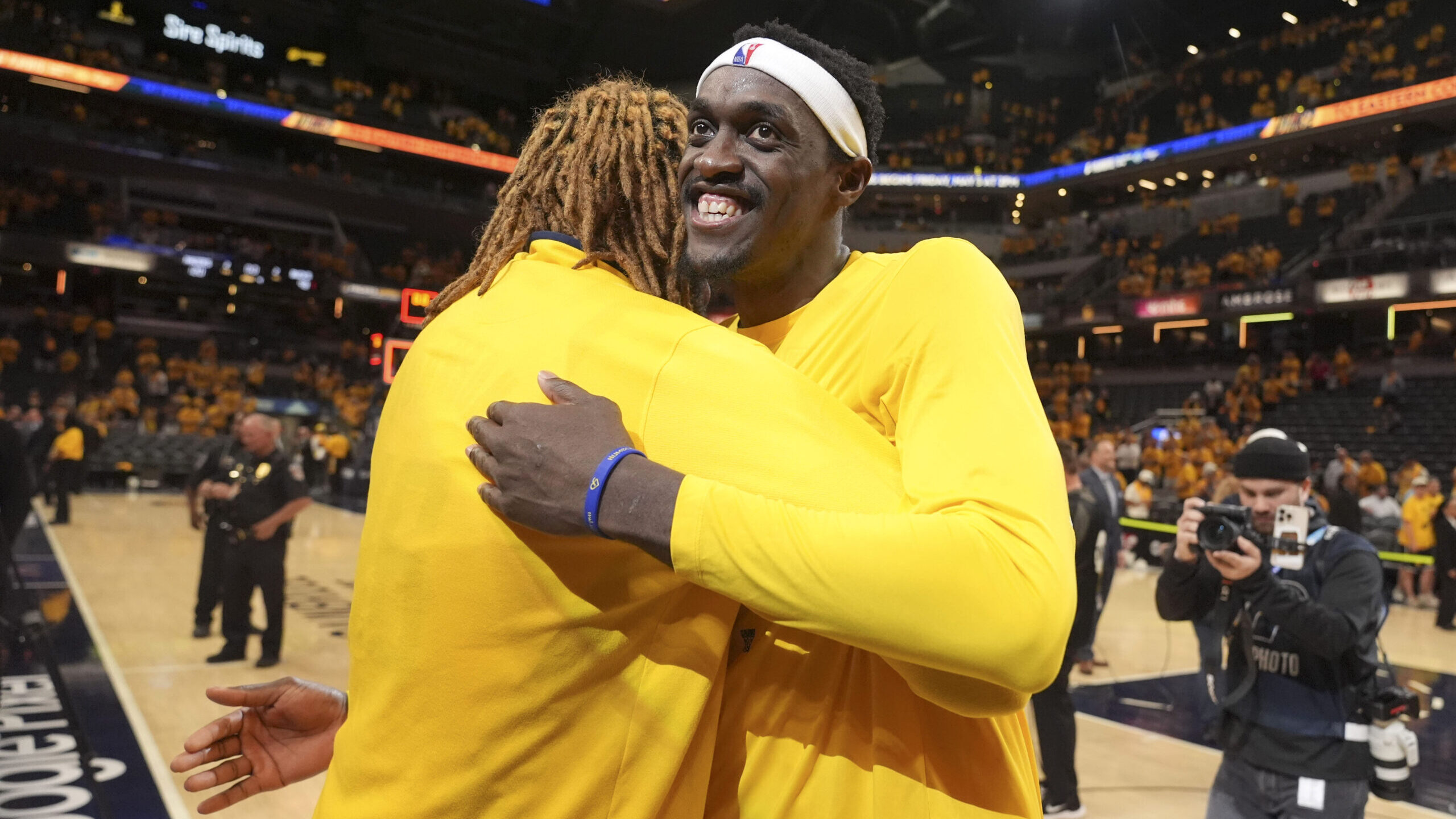 Indiana Pacers forward Pascal Siakam, right, gets a hug from teammate James Johnson after Game 6 ag...
