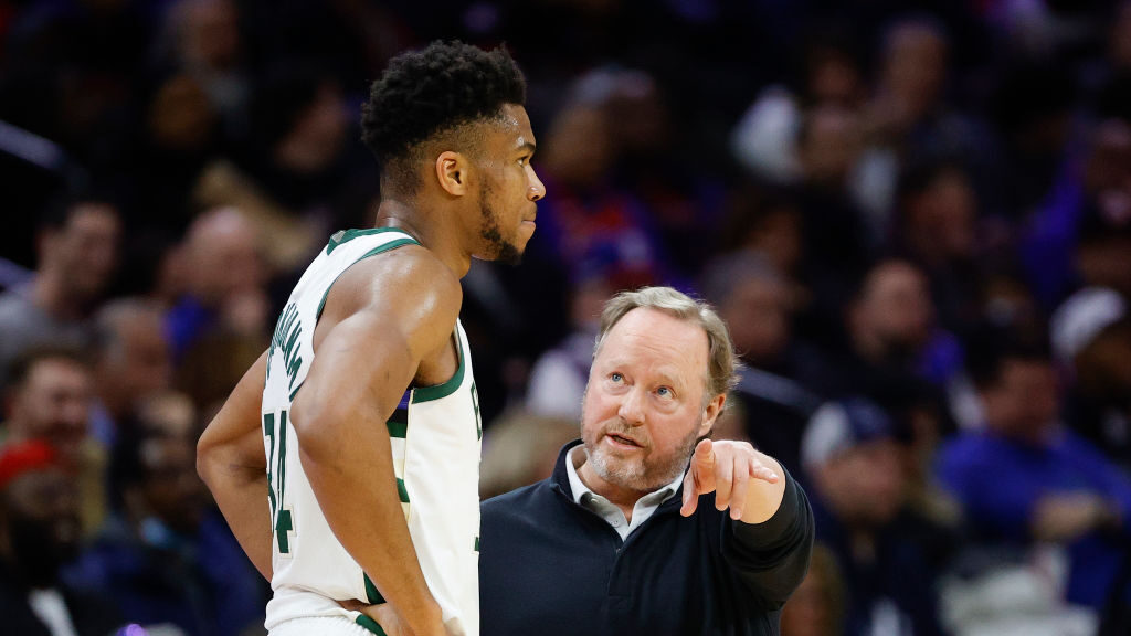Head coach Mike Budenholzer (R) speaks with Giannis Antetokounmpo #34 in a game against the Philade...