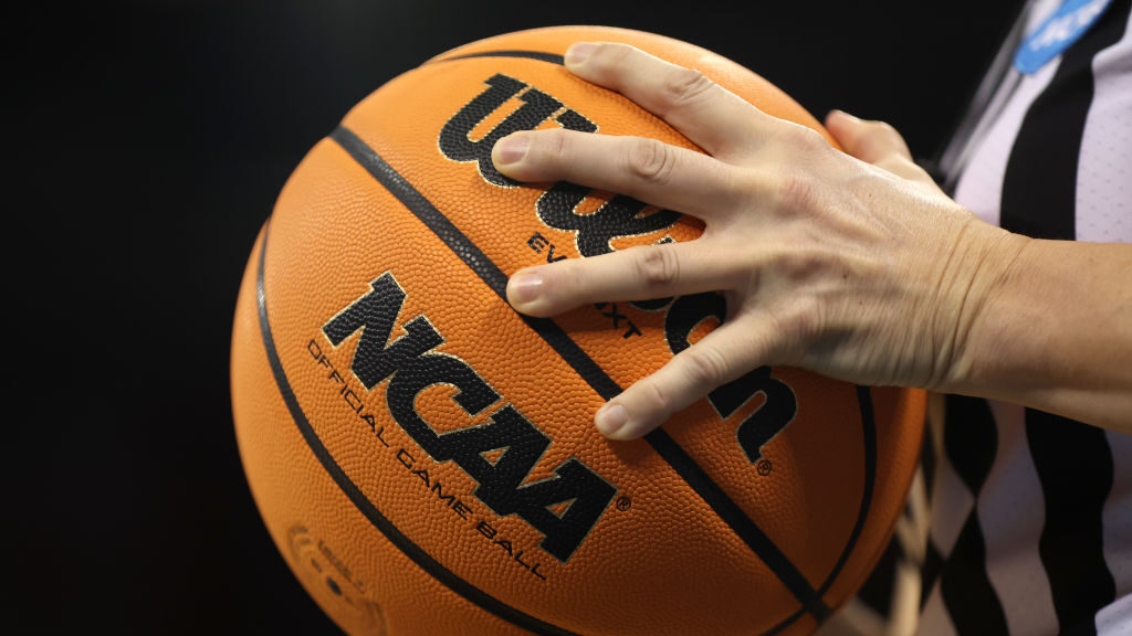 The NCAA logo is seen on the game ball during the first round of the NCAA Men's Basketball Tourname...