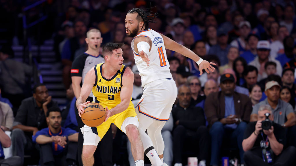 T.J. McConnell #9 of the Indiana Pacers attempts to pass around Jalen Brunson #11 of the New York K...