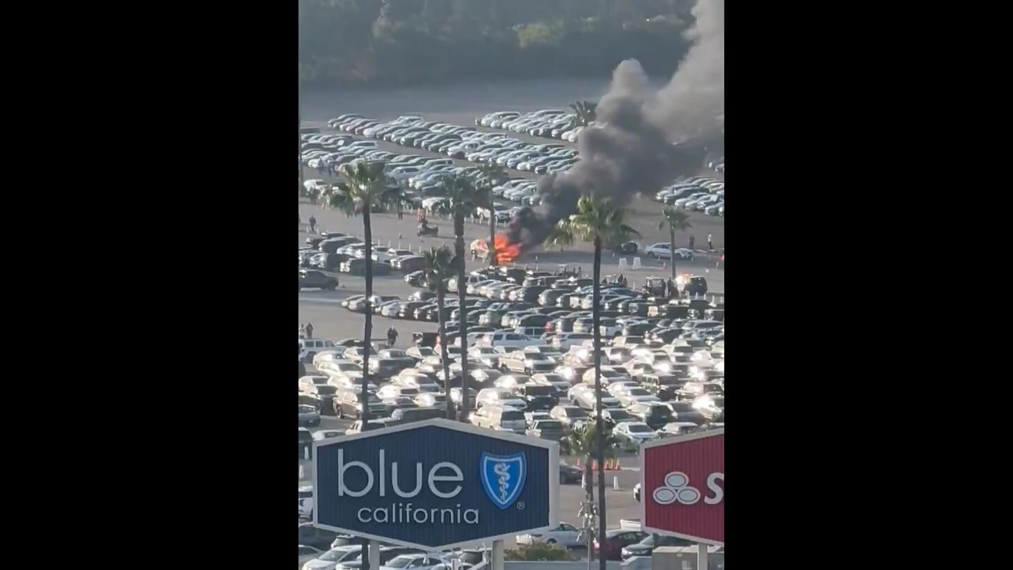 A car burns in the Dodgers Stadium parking lot on Wednesday, May 22, 2024....