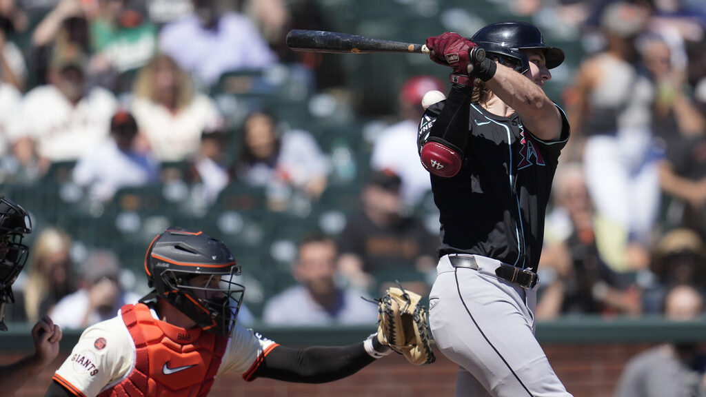 Arizona Diamondbacks' Jake McCarthy, right, strikes out swinging on a ball that gets past San Franc...