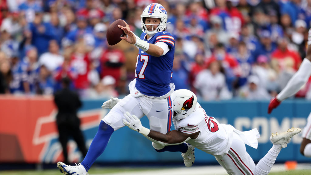 Buffalo Bills QB Josh Allen tries to avoid the tackle against the Cardinals...