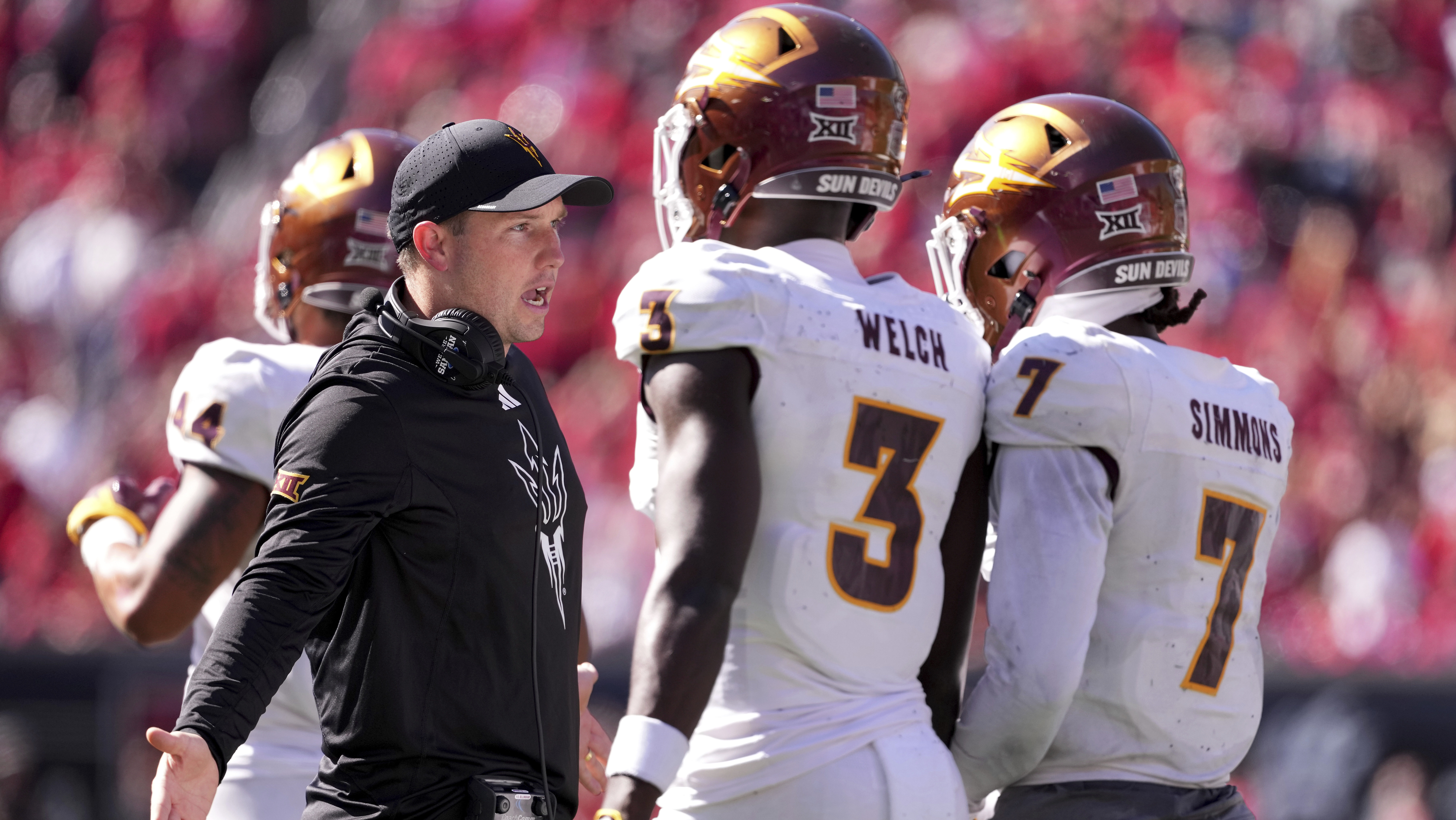 Arizona State head coach Kenny Dillingham talks to his players as the come off the field during the...