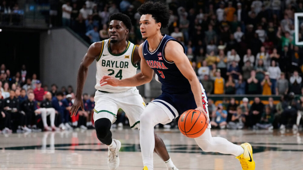 Arizona guard Brayden Burries (5) drives to the basket as Baylor's Tounde Yessoufou (24). Burries i...