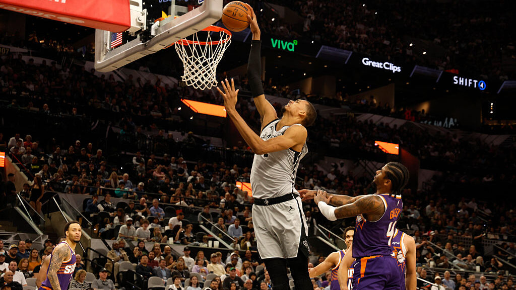 SAN ANTONIO, TEXAS - MARCH 19: Victor Wembanyama #1 of the San Antonio Spurs dunks on Jalen Green #...