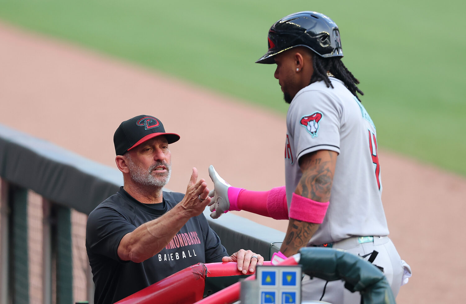 Manager Torey Lovullo #17 congratulates Ketel Marte #4 of the Arizona Diamondbacks after hitting a ...