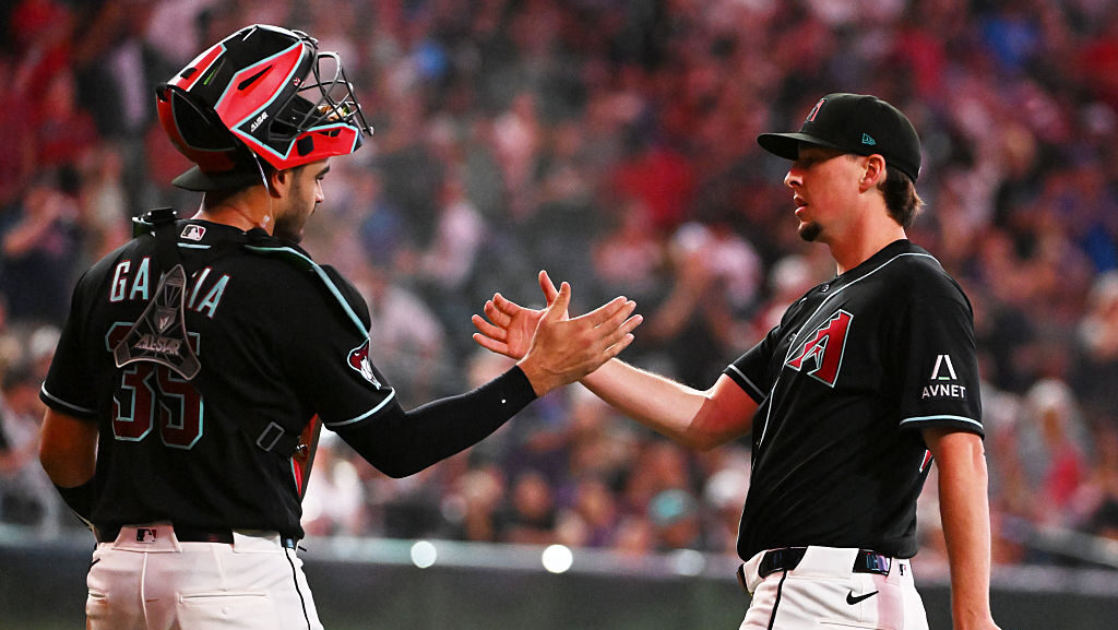 PHOENIX, ARIZONA - MAY 24: Taylor Clarke #45 and Aramis Garcia #35 of the Arizona Diamondbacks cele...