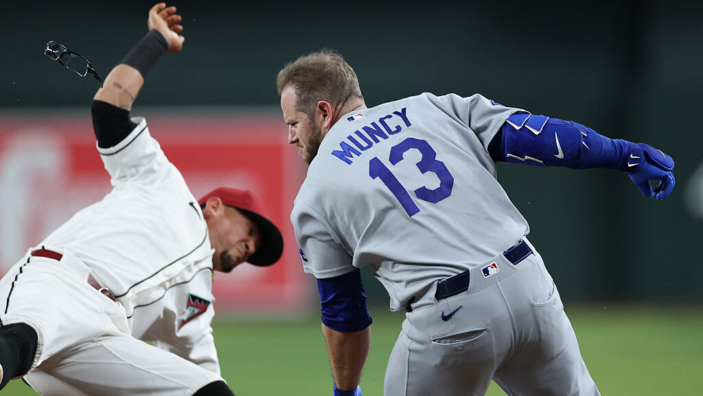 PHOENIX, ARIZONA - JUNE 04: Max Muncy #13 of the Los Angeles Dodgers collides with Ildemaro Vargas ...