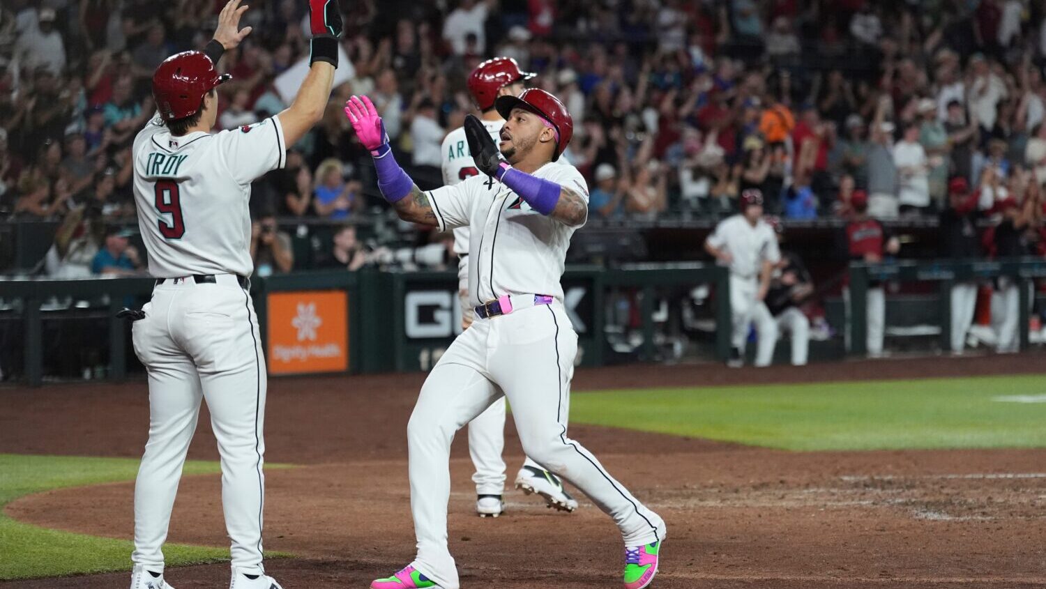 Arizona Diamondbacks' Tommy Troy (9) and Ketel Marte celebrates their runs scored against the San F...