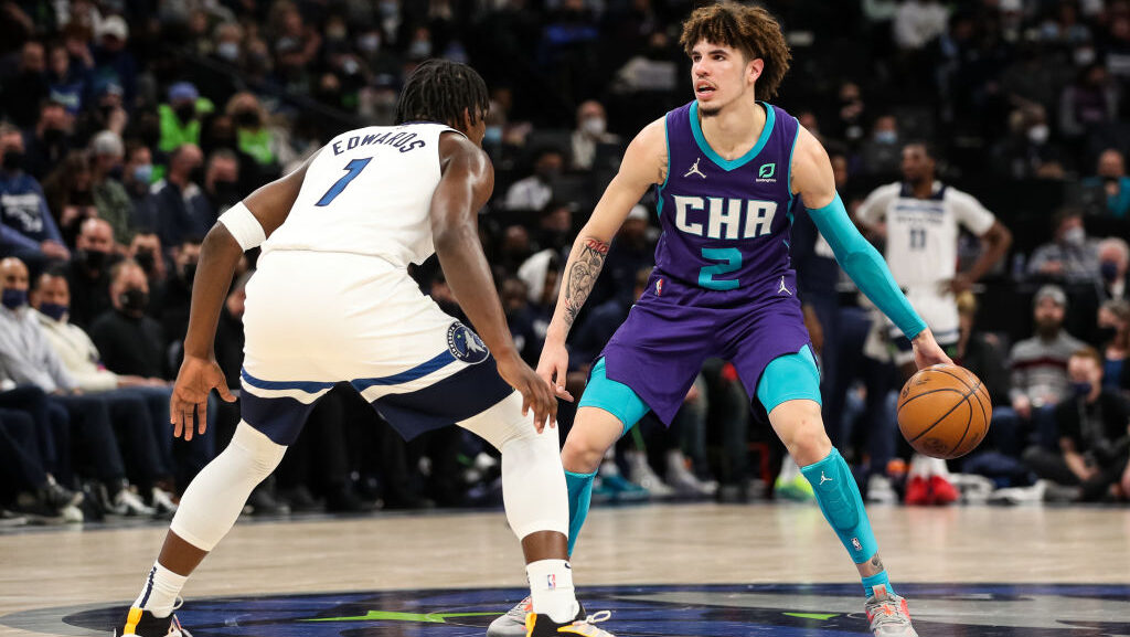 LaMelo Ball #2 of the Charlotte Hornets dribbles the ball while Anthony Edwards #1 of the Minnesota...