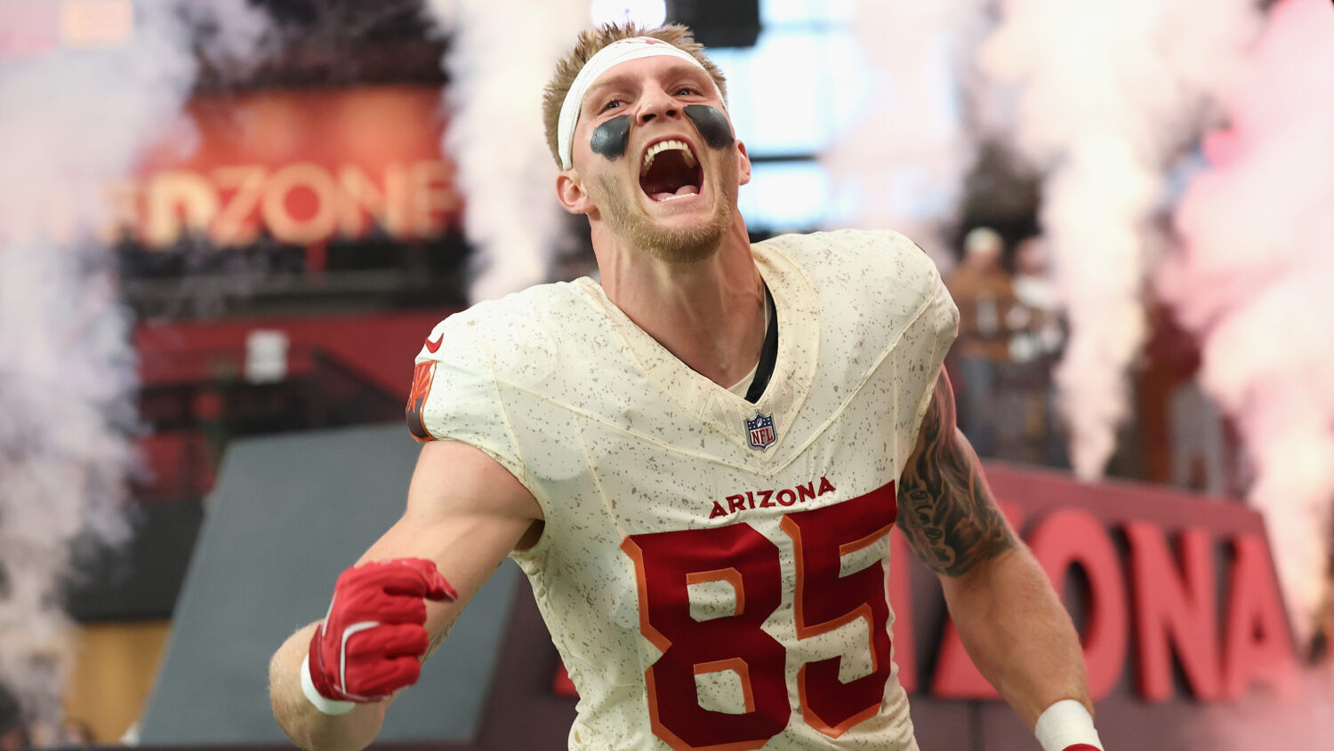 GLENDALE, ARIZONA - SEPTEMBER 25: Trey McBride #85 of the Arizona Cardinals runs onto the field dur...